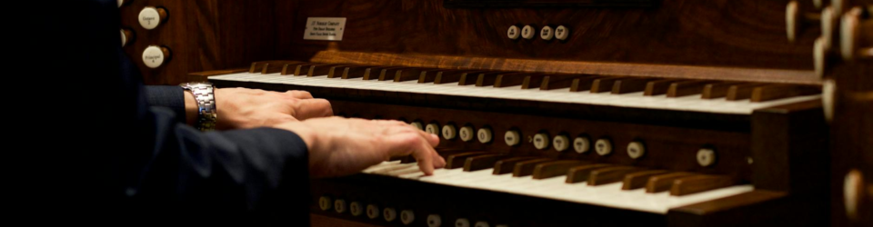 close up of a person playing the organ